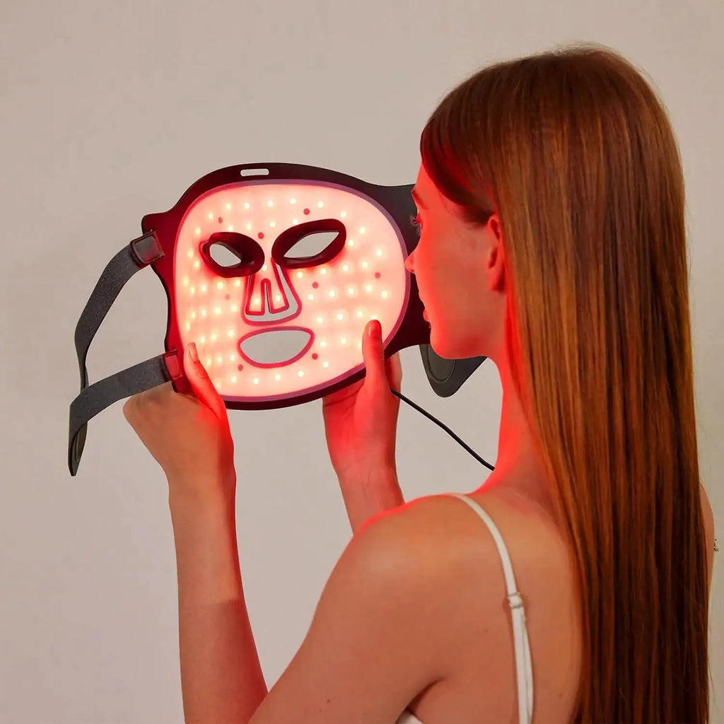Woman using the Lumé Halo LED light therapy mask